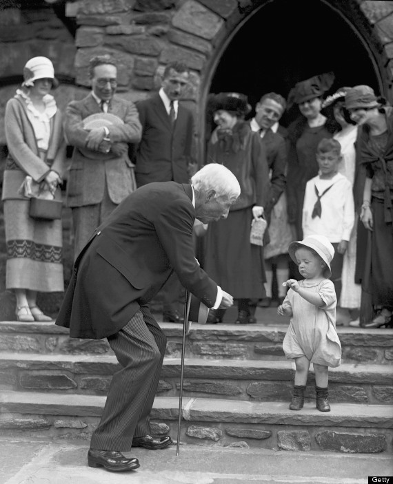 UNITED STATES - JULY 08: John D. Rockefeller marks his 84th birthday by handing out a nickel to Robert Irving Hunter, 2, who politely gives it back at first, after services at New Community Church in Westchester County. (Photo by NY Daily News Archive via Getty Images)