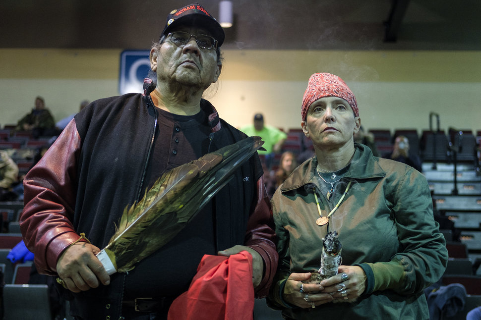 U.S. Army veterans Aloysious Bell, left, and Tie Kobolson, hold ceremonial feathers and a smudge stick during a forgiveness ceremony for veterans at the Four Prairie Knights Casino & Resort on the Standing Rock Sioux Reservation on Monday, Dec. 5, 2016.