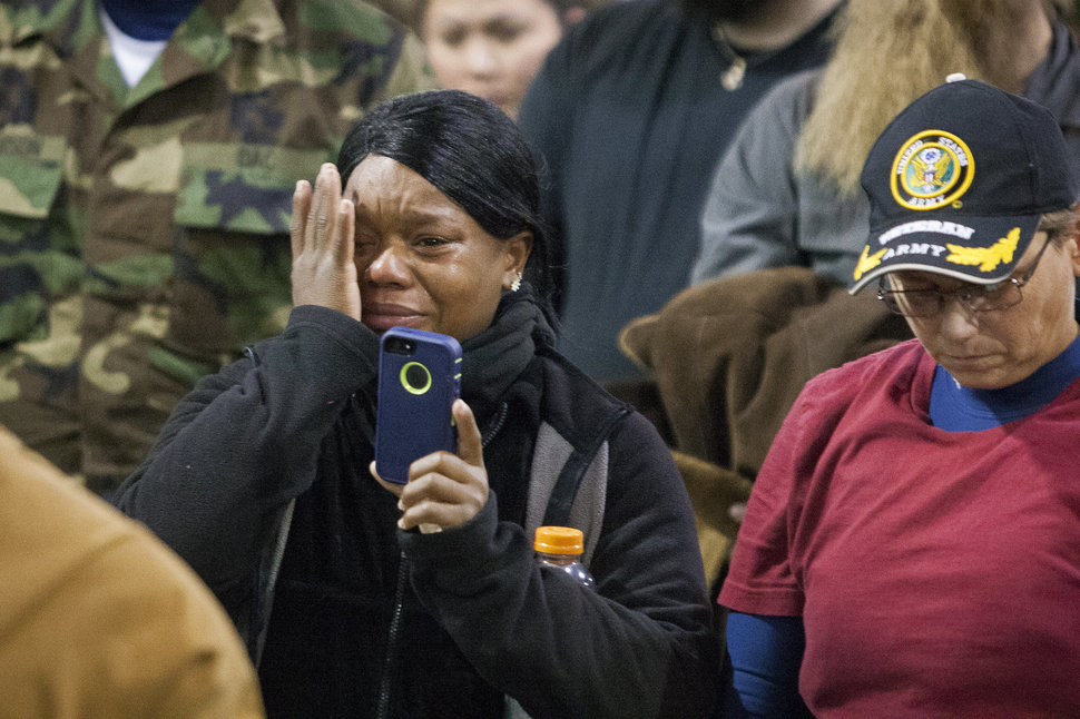 Veteran Tatian McLee wipes tears from her eyes as she films Lakota elders speak during a forgiveness ceremony for veterans at the Four Prairie Knights Casino & Resort on the Standing Rock Sioux Reservation on Monday, Dec. 5, 2016.